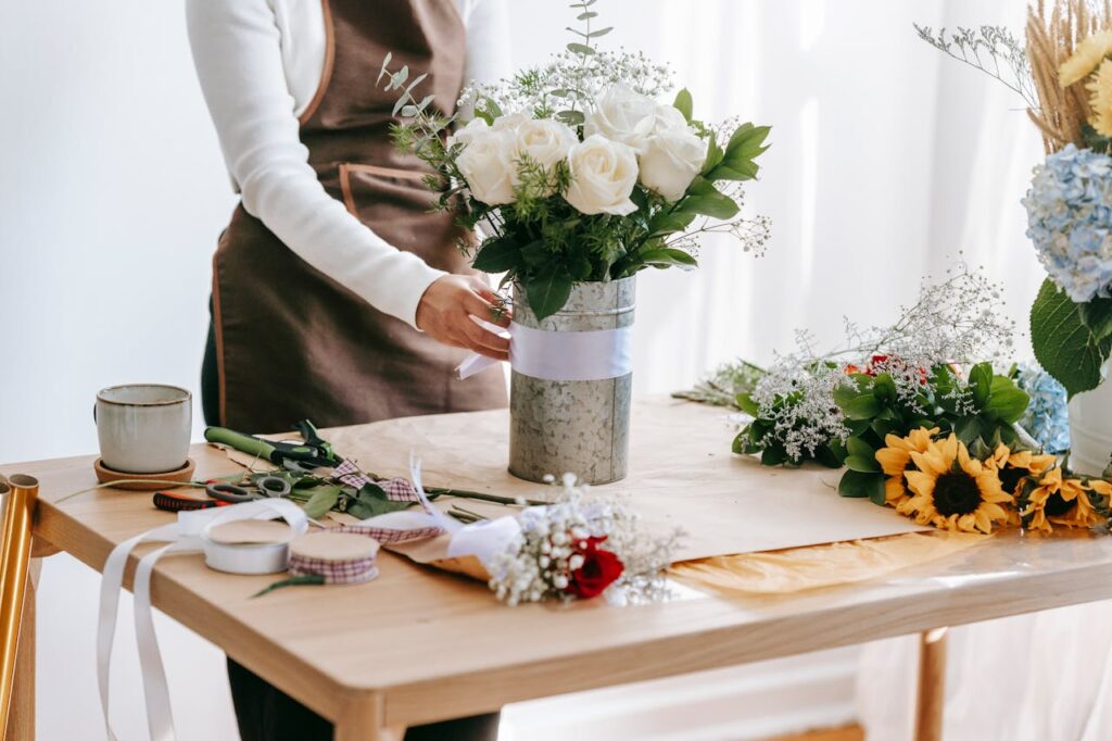 pexels-photo-6913143 Florist making festive bouquet in light room